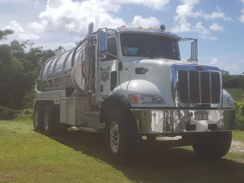 Barrett's white septic pump truck with the S.W.A.T. logo on the door
