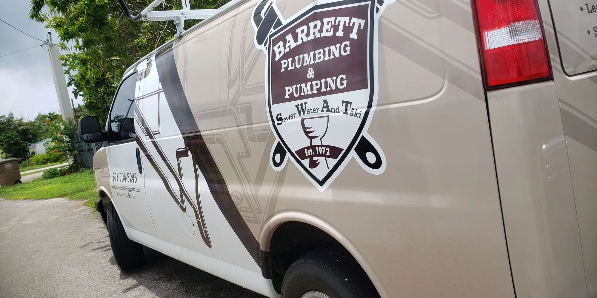 Barrett Plumbing & Pumping van with the S.W.A.T. shield badge on its side